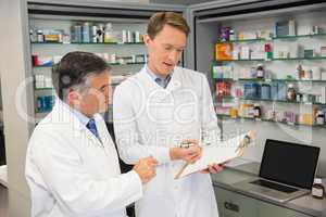 Team of pharmacists looking at clipboard