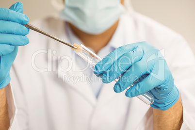 Food scientist putting raw chicken in test tube