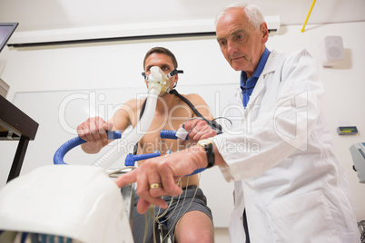 Doctor with man doing fitness test