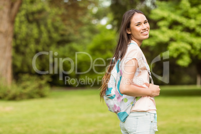 Portrait of a smiling student with a shoulder bag