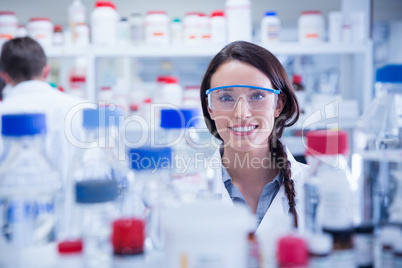 Portrait of a smiling chemist wearing safety glasses