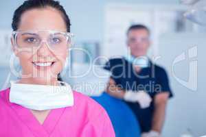 Smiling assistant with protective glasses