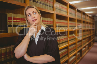 Serious lawyer thinking with hand on chin