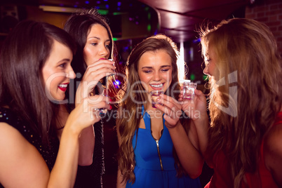 Pretty friends drinking shots together