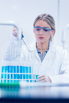 Science student using pipette in the lab