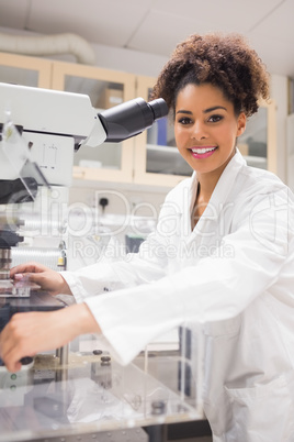 Pretty science student using microscope Pretty science student using microscope