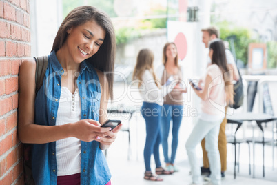 Pretty student using her smartphone