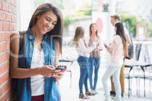 Pretty student using her smartphone