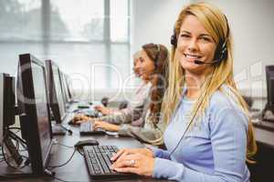 Smiling call centre agent talking on the headset