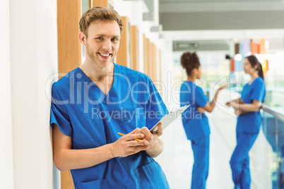 Medical student smiling at camera in hallway