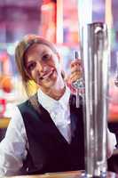 Pretty barmaid pulling pint of beer