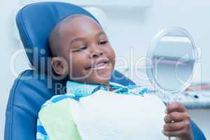 Boy looking at mirror in the dentists chair