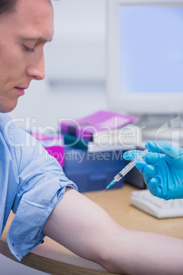 Doctor about doing an injection to the patient arm