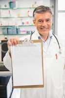 Happy pharmacist showing page on clipboard