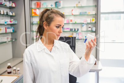 Junior pharmacist looking at medicine
