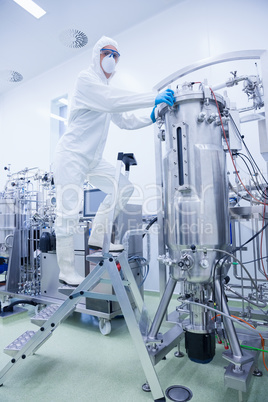 Scientist standing on ladder looking at the camera