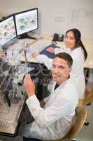 Biochemistry students using large microscope and computer