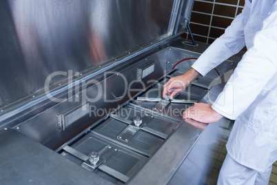 Close up of a focused brewer working at machine