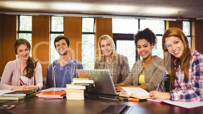 Smiling students working together on an assignment