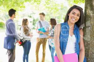 Pretty student smiling at camera outside