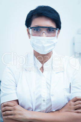 Dentist wearing surgical mask and safety glasses