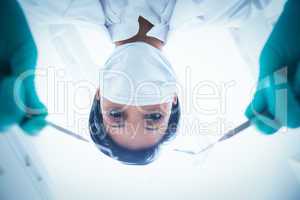 Female dentist in surgical mask holding dental tools