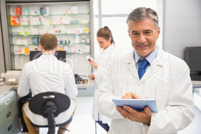 Senior pharmacist using tablet pc