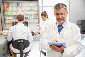 Senior pharmacist using tablet pc