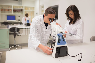 Medical students working with microscope