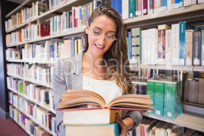 Pretty student reading books in library