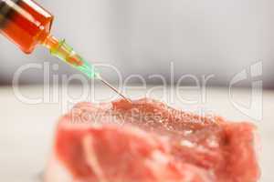 Food scientist injecting raw meat