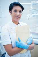 Female dentist holding reports