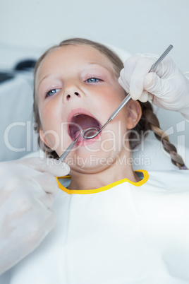 Close up of girl having her teeth examined