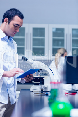 Science student working with microscope in the lab