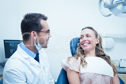 Dentist examining young womans teeth