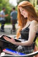 Pretty student studying outside on campus