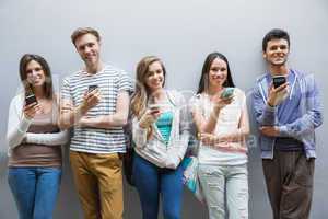 Students using their smartphones in a row