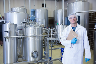 Man holding a clipboard standing in front of the container