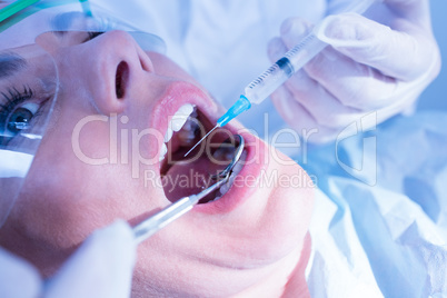 Dentist about to give injection to terrified patient
