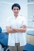 Confident female dentist with arms crossed