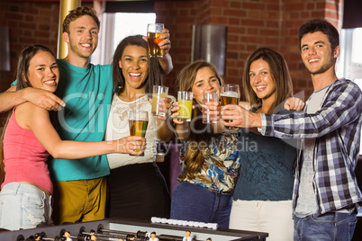 Portrait of happy friends toasting with mixed drink and beer