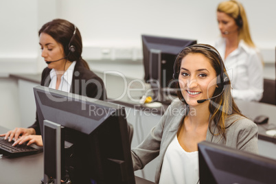 Smiling call centre agent talking on the headset