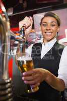 Pretty barmaid pulling pint of beer