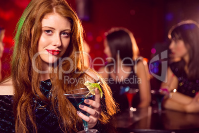 Pretty redhead drinking a cocktail