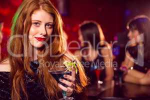 Pretty redhead drinking a cocktail