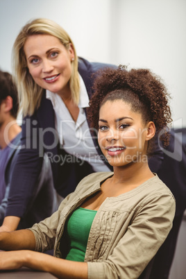 Cheerful teacher and student looking at camera