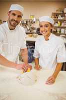 Team of bakers preparing dough