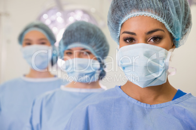 Medical students in operating theater looking at camera