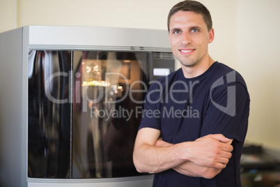 Engineering student smiling beside 3d printer