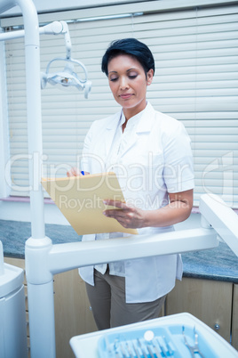 Female dentist reading reports